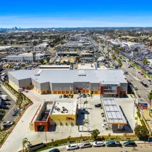 Aerial view of an A-1 Self Storage facility with numerous storage units, a parking lot, and surrounding buildings.