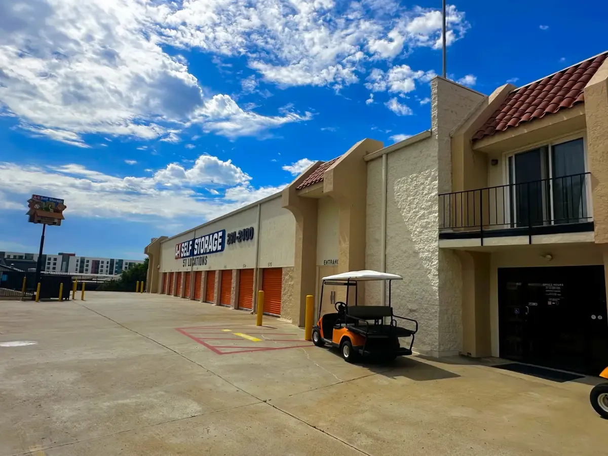 Golf cart, drive-up units, and front office at the entrance to the storage facility.